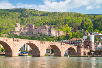 The Carl Theodor Old Bridge located next to Neckar river in Heidelberg, Germany with Heidelberg Castle in the background