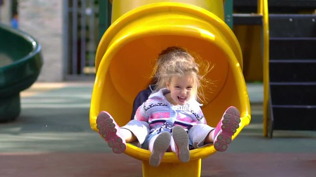 Little girls on playground. Slow motion