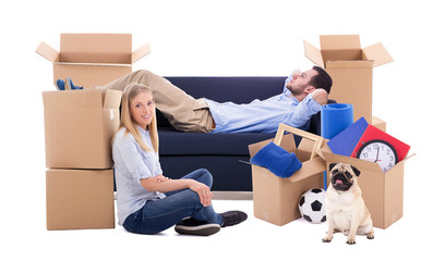 moving day concept - tired couple and cardboard boxes with stuff isolated on white