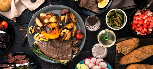 Grilled steak with grilled vegetables, beer and wine