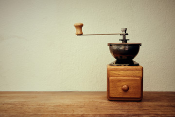 Old coffee grinder, manual hand mill on the table. vintage style. - Powered by Adobe