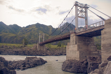 Suspension bridge on the Katun River. Altai Mountains