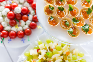 A small table with a delicious buffet of canapes, caviar, sandwiches