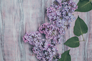 Creative layout is made with lilac on wooden table. Concept of nature. Flat lay