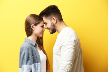 Cute young couple on color background