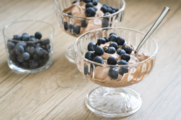 Two cups of chocolate cream with blueberries