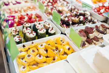 Assorted marinated vegetables and olives on farmer's market in small town in Europe