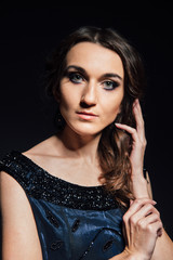 Obraz premium Studio portrait of woman on a dark background