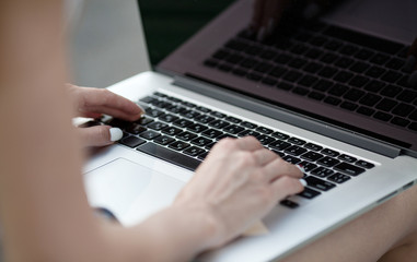 woman hands on a laptop. Selective focus.