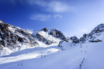 Fototapeta na wymiar Winter snow covered mountain peaks in Europe. Great place for winter sports