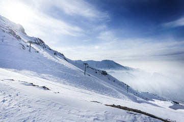 Fototapeta na wymiar Winter snow covered mountain peaks in Europe. Great place for winter sports