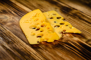 Sliced cheese on wooden table