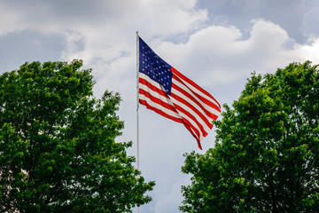 Flag pole in the sky with clouds