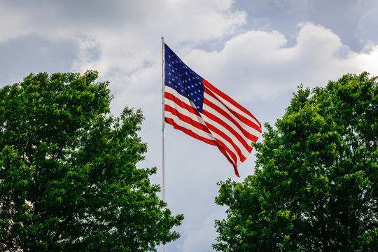Flag pole in the sky with clouds