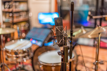 A view of a drum kit set up for recording in a recording studio with microphones in place