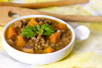 Lentil casserole on wooden table on yellow tablecloth