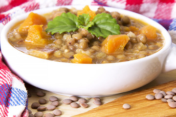 Lentil casserole on the wooden table on the red tablecloth