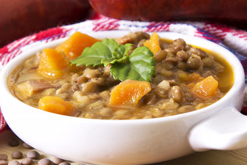 Lentil casserole on the wooden table on the red tablecloth