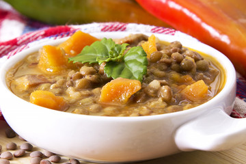 Lentil casserole on the wooden table on the red tablecloth