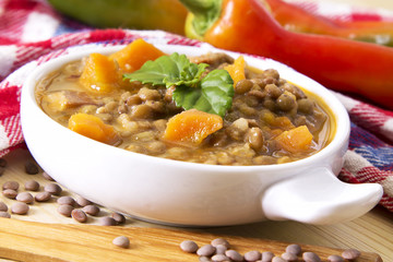 Lentil casserole on the wooden table on the red tablecloth