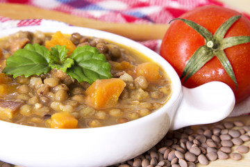 Lentil casserole on the wooden table on the red tablecloth