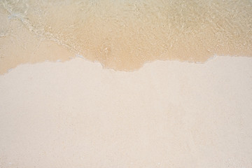 Fototapeta na wymiar Soft wave on sandy beach background