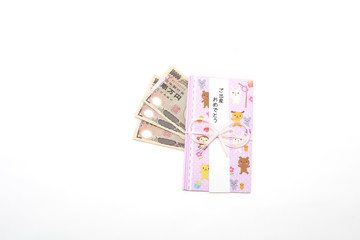 Obraz na płótnie Canvas 白背景のご出産の袋と一万円札　Celebration bag with white background and 10,000 yen bill