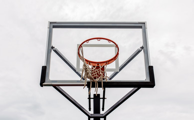 Fototapeta na wymiar Basketball hoop with sky background