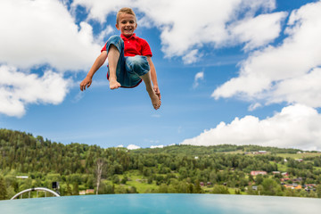 Young boy jumping on trampoline