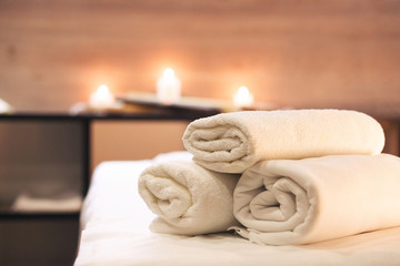 Fototapeta na wymiar Spa and wellness concept, white towels in massage parlor