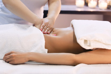 Fototapeta na wymiar Young woman having abdomen massage