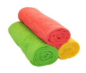Yellow, green and red rolled up  towels isolated