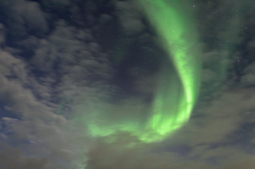 Polar lights, the aurora and the stars visible through the clouds.