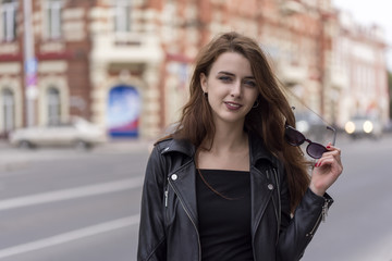 Fototapeta premium Girl with long hair posing on city street