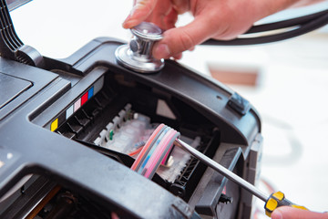 Repairman repairing broken color printer
