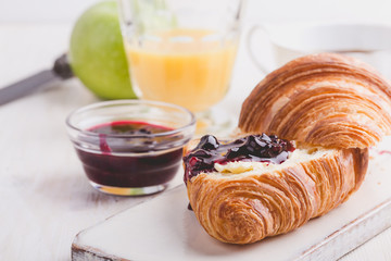 Breakfast with croissant, jam,  orange juice and coffee