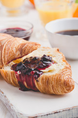 Breakfast with croissant, jam,  orange juice and coffee