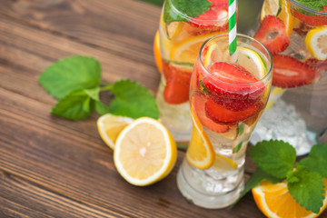 Mojito cocktail and ingredients, lemon, strawberry and orange