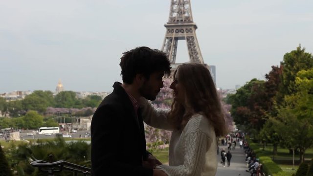 man kissing hand of woman in Paris, silhouette