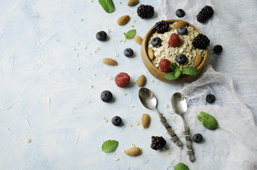 Healthy breakfast with oat flakes, raspberry berries, blueberries, selective focus