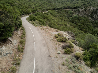 Fototapeta premium Aerial view of small curvy road in Corsica