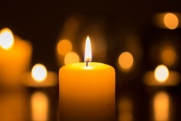 candle flame glowing in darkness - 158347590