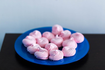 Marshmallow, Meringue,zephyr .The blue plates on a white background