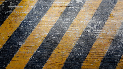 Background with asphalt road texture and hazard stripes