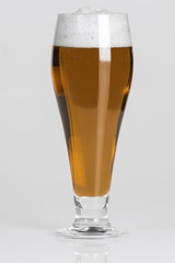 Glass of cold ruby beer on a white background isolated