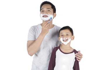 Father and son with shaving foam
