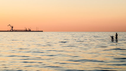 Fototapeta premium Couple bathing at sunset in the sea
