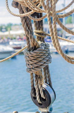 Rigging on the old sailboat against the background of modern yac