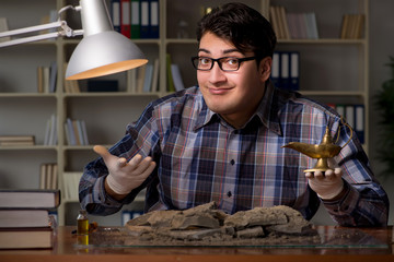 Archeologist working late night in office