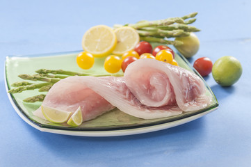 raw white fish fillets with tomatoes and fresh oregano & Lemon slice 
